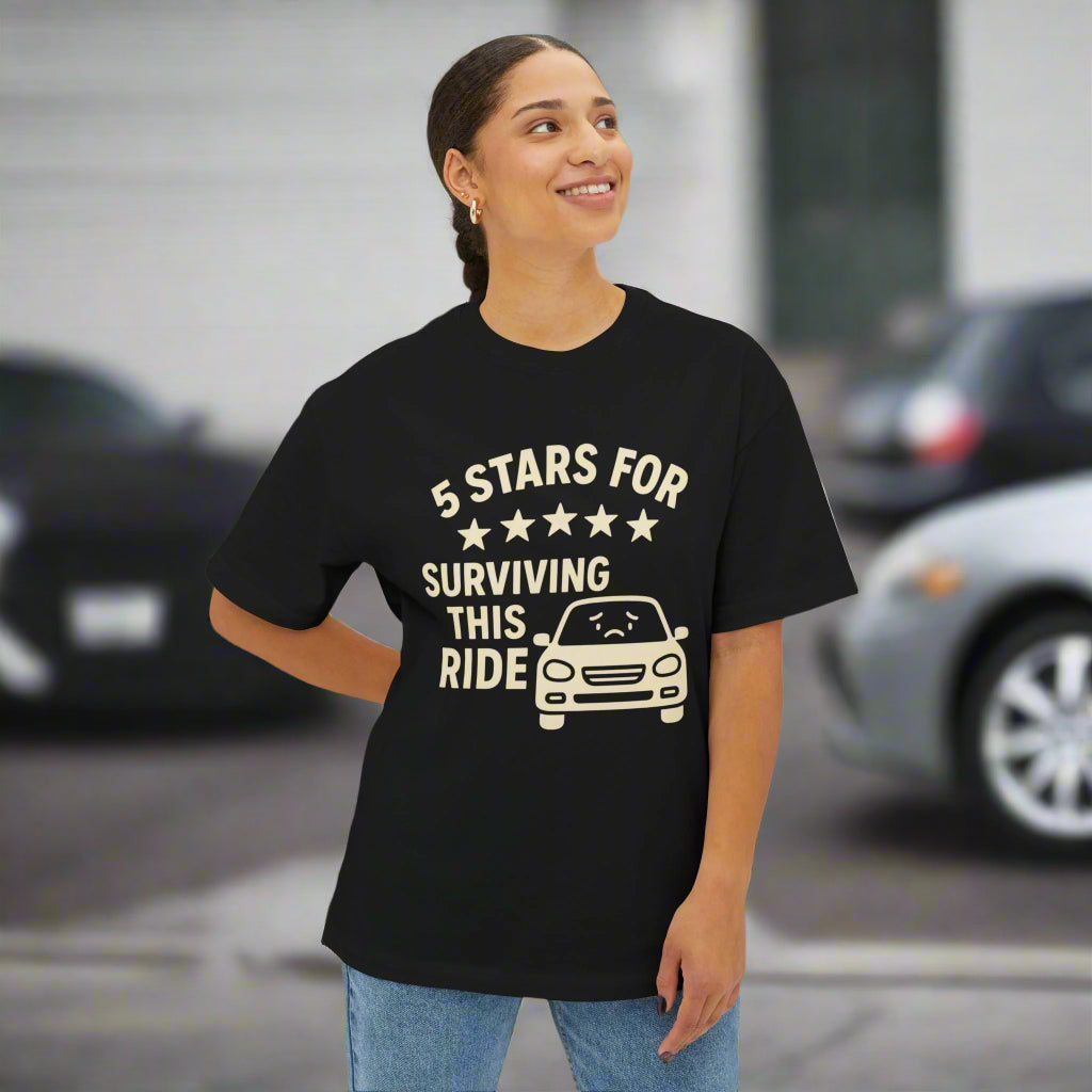 Person wearing a black t-shirt with humorous text design on a white background that says 5 stars for surviving this ride.