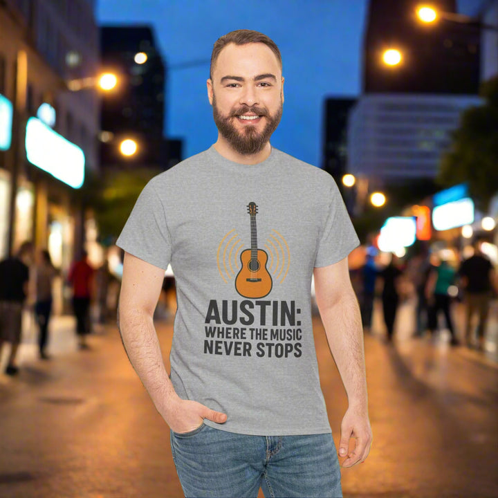 Man wearing a gray t-shirt with a guitar graphic and text on a white background