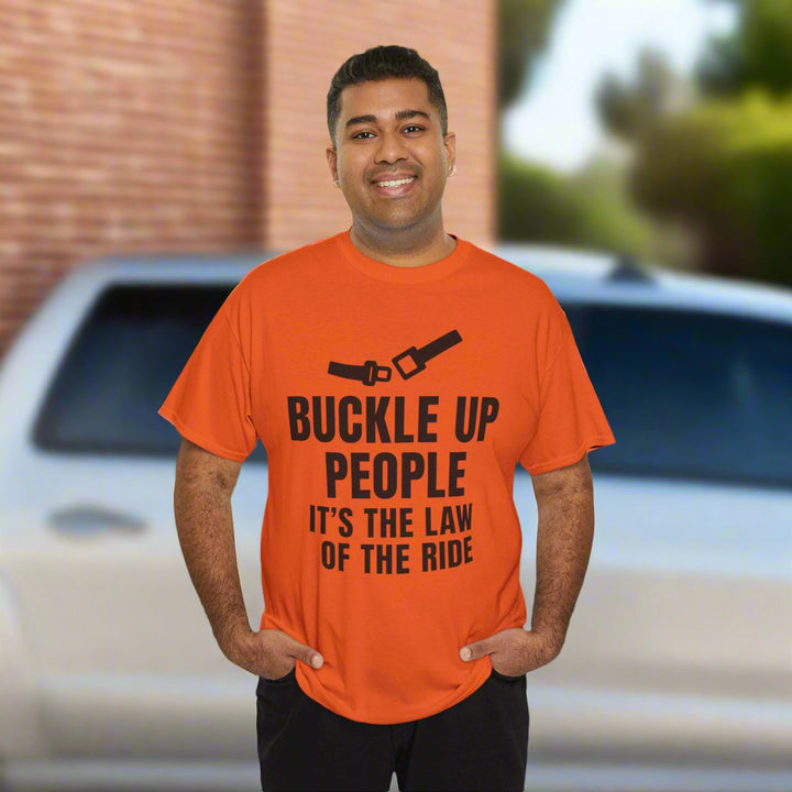 Man wearing an orange t-shirt with a humorous safety message on a white background
