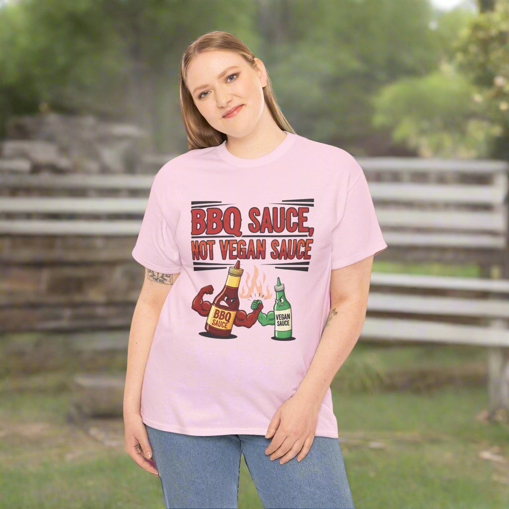 Person wearing a pink t-shirt with BBQ sauce not vegan sauce graphic