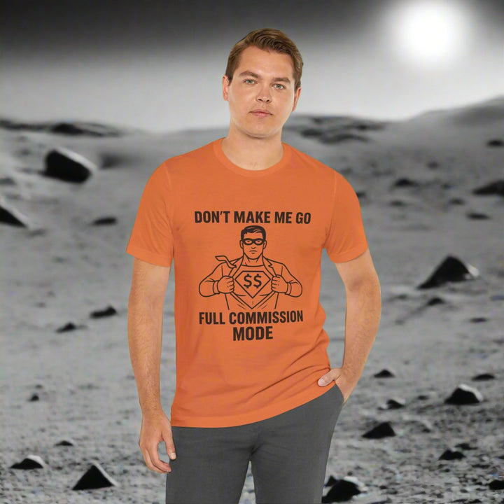 Man wearing an orange t-shirt with a superhero graphic and text on a white background
